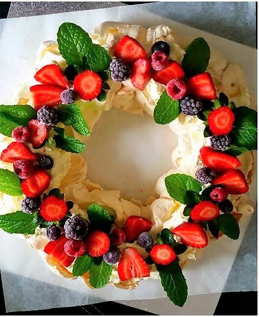 Christmas wreath pavlova with berries and holly